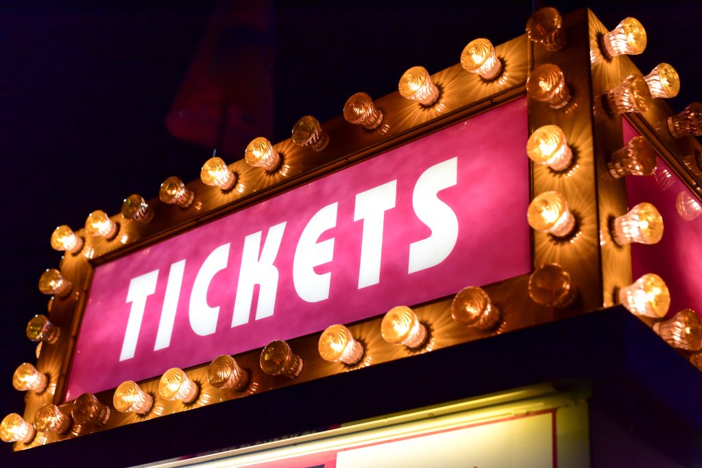 A custom lighted marquee sign that says “tickets”.