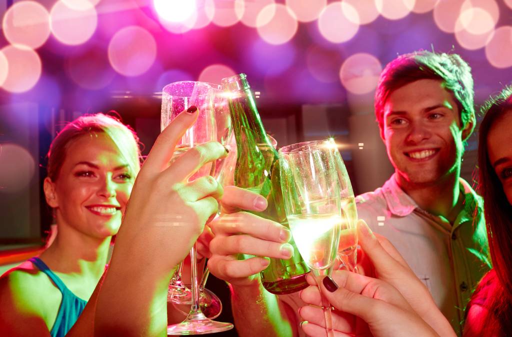 A group of friends toasting at a nightclub.